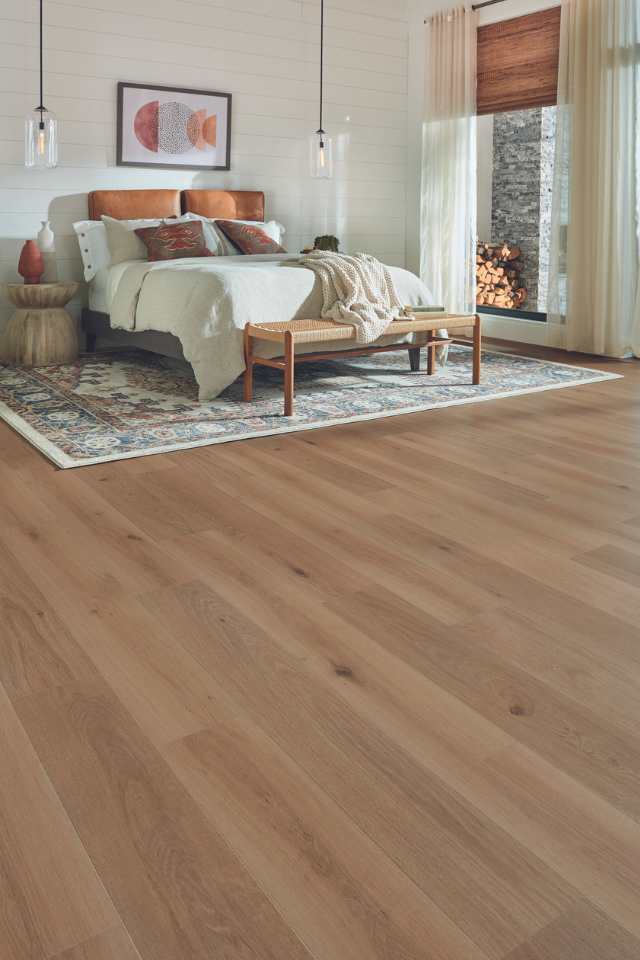 wood look laminate in earth toned bedroom with white shiplap walls